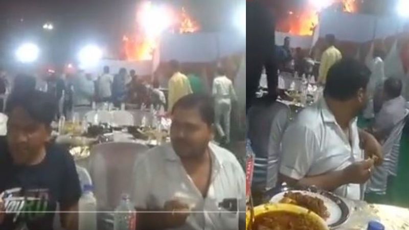 The Venue is on Fire and So is Their Stomach: Two Men Gobbles Food with Fire in the Background