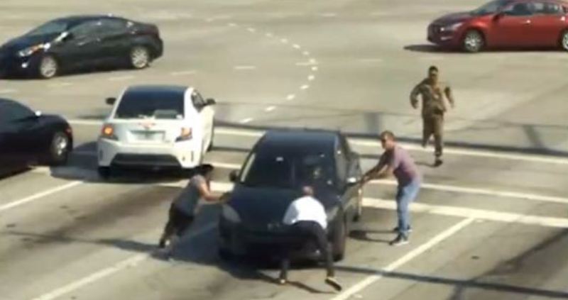Caught on Cam: People Stop Car with Bare Hands to Save Woman Driver Having a Medical Emergency